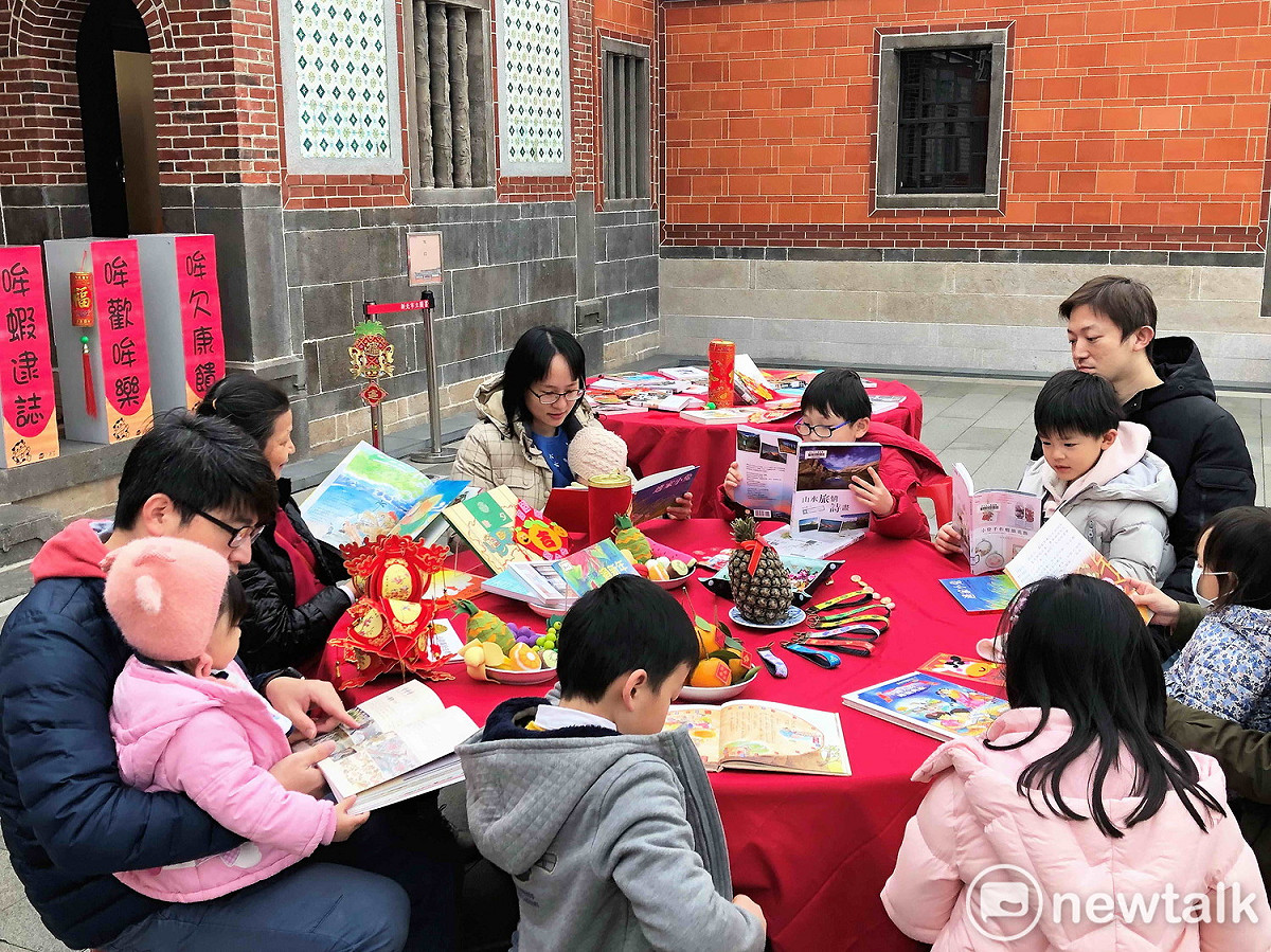 新北市立圖書館五股分館特別在五股守讓堂的前埕打造年節圍爐的熱鬧氣氛，邀讀者提前書香圍爐。 圖：王峻昌／攝