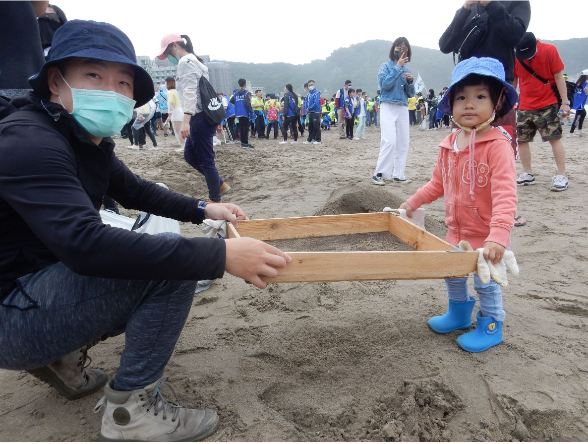 民眾以篩網進行淨灘。 圖：新北市環保局提供