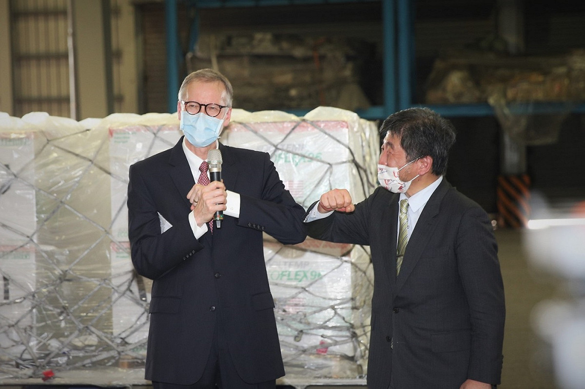 中央疫情指揮中心指揮官陳時中（右）和美國在台協會（AIT）處長酈英傑（左）一同至桃園機場督導美國政府捐贈250萬劑莫德納疫苗的卸載及後送作業。 圖：食藥署／提供