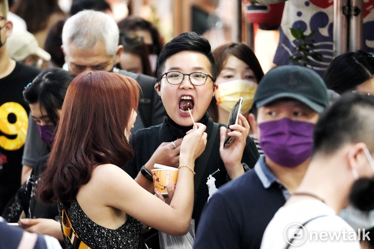 疫情警戒降級首日，基隆廟口夜市迎來兩個多月來首見的人潮，許多名店前擠滿了排隊人潮，人與人之間已無社交距離空間，處處摩肩擦踵到，人們脫下口罩，享受睽違多時的大快朵頤的快感！預料越晚越熱鬧。 圖：張良一/攝