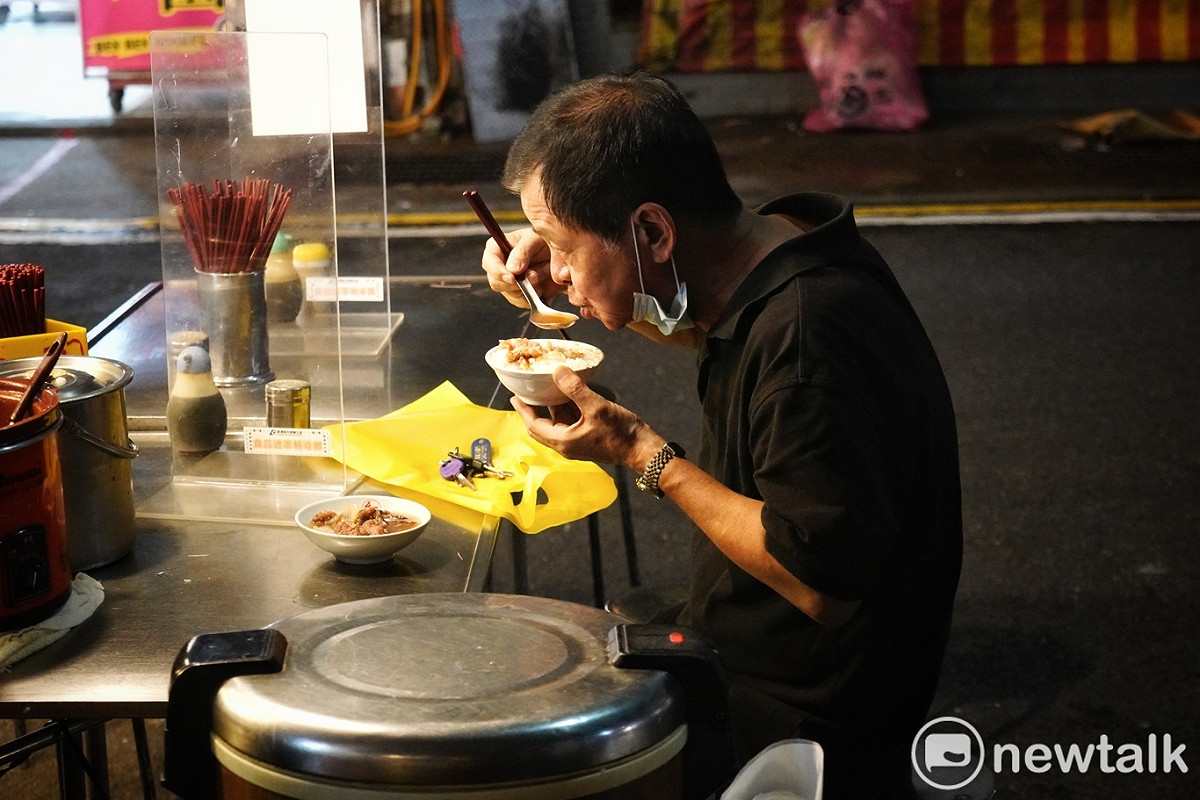 一位市民在鰻魚羹攤子享受鰻魚羹和滷肉飯美食。 圖：張良一/攝