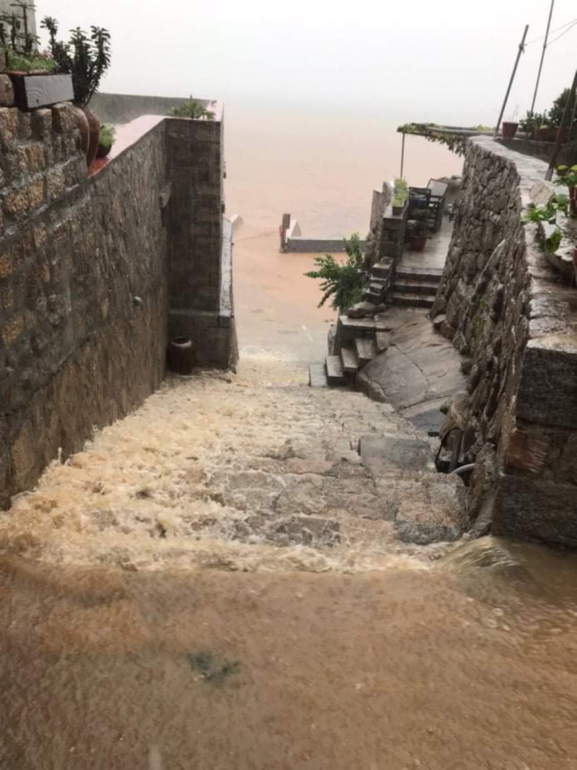 熱帶性低氣壓引發暴雨成災，北竿部份地區淹水及腰，大水順著階梯流進海裡。 照片：北竿鄉民line群組
