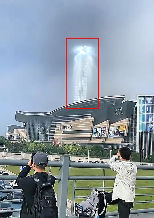 中國瀋陽的一間商場的上空出現了巨大光柱，引來民眾旁觀、拍照。 圖 : 翻攝自網易
