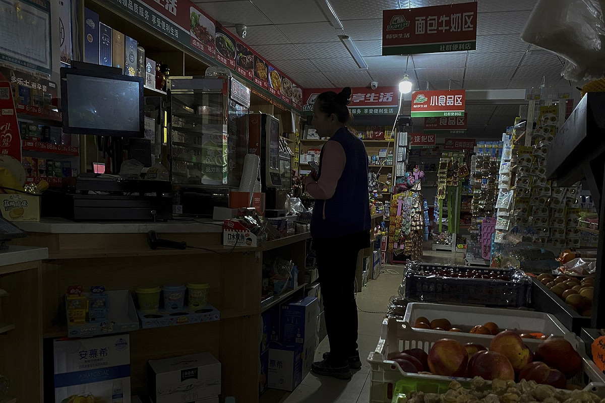商店營業也大受影響，商店內同樣只亮著一顆小燈泡 圖:達志影像/美聯社