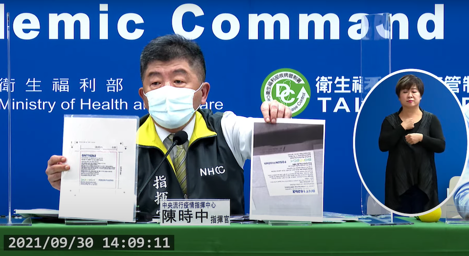 指揮官陳時中今在記者會現場秀出將到貨的客製化BNT疫苗瓶身和盒裝的照片，強調和契約內要求的條件和實際狀況符合。 圖：翻攝自指揮中心直播畫面