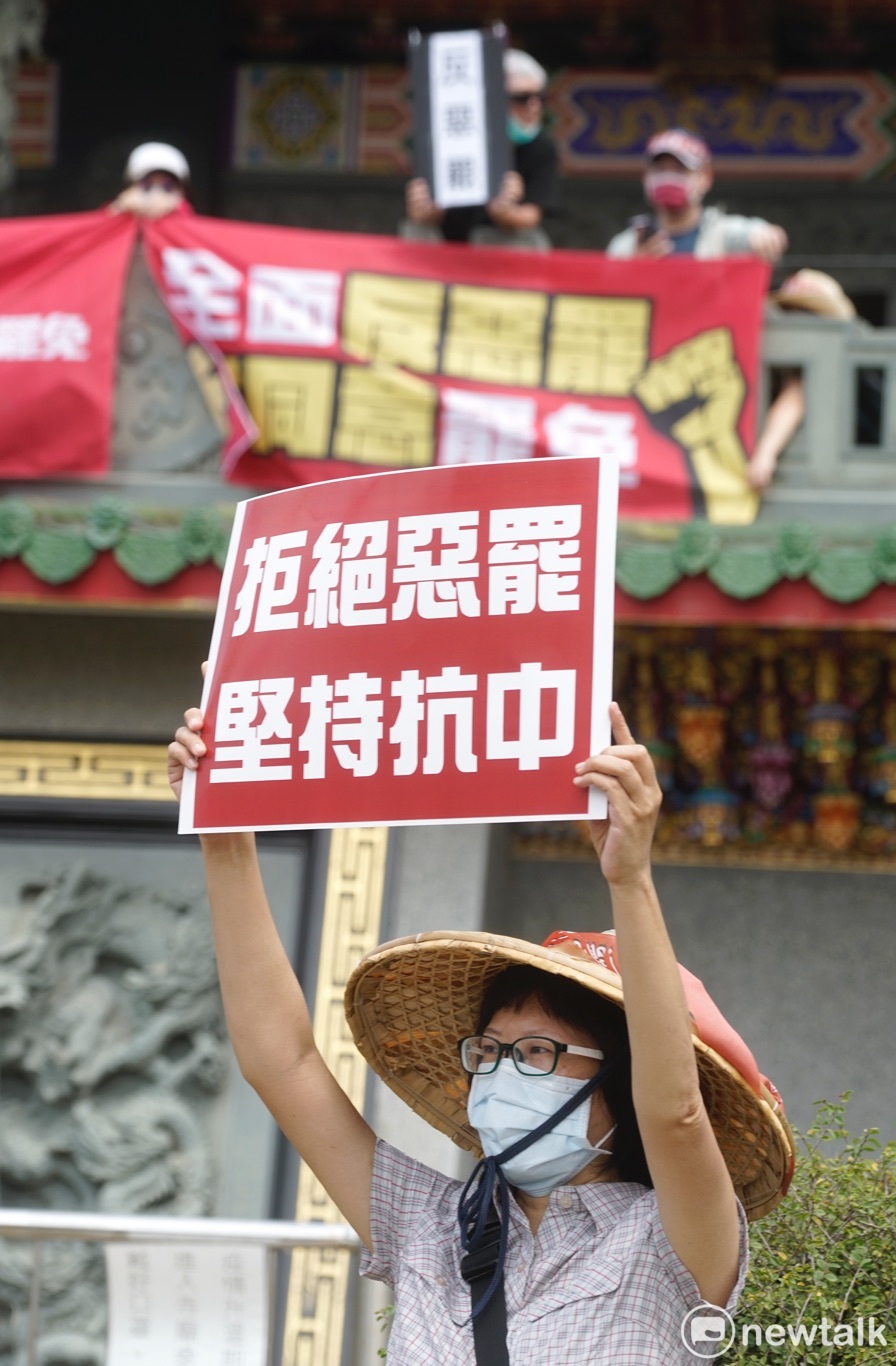 支持者在龍井龍泉岩祖師廟前舉牌反罷免立委陳柏惟。 圖：張良一/攝