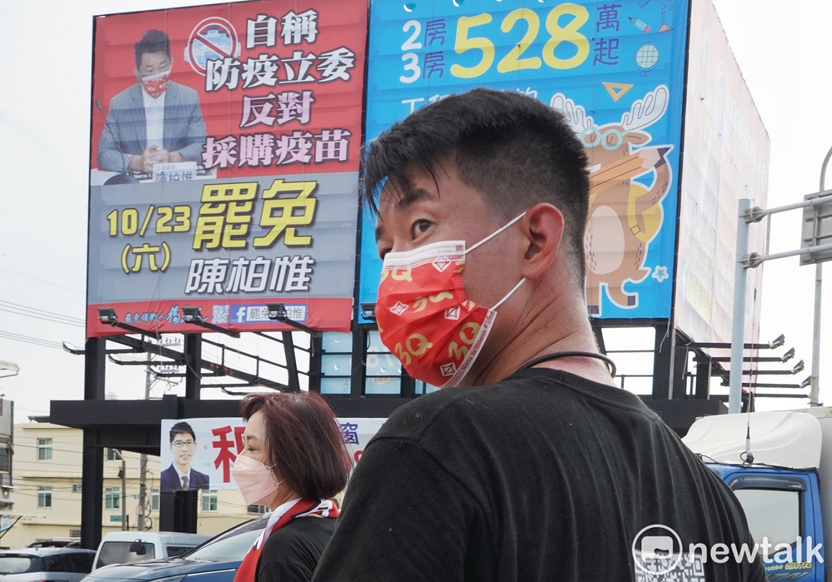 陳柏惟上午在支持者陪同下，在龍井市區苦行，希望市民在下週末的罷免投票時，投下不同意罷免。圖為陳柏惟經過龍井市區一處由罷免方的罷免看板。 圖：張良一/攝