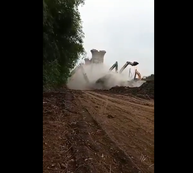 橋墩往後倒塌，並撞上兩台挖土機，揚起大量塵灰。 圖：翻攝自twitter.com/AlBurhanCenter
