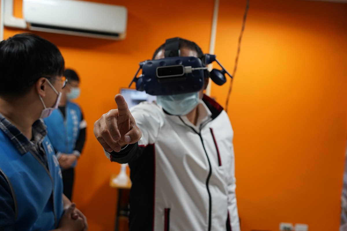 侯友宜透過全罩式頭盔及3D軟體了解各項抽水站機組操作程序。 圖：新北市水利局提供