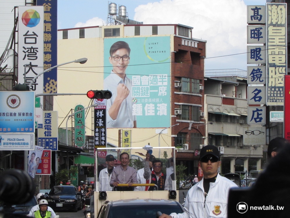 國民黨總統候選人朱立倫4日與屏東市立委候選人王進士掃街2個小時，路上四處可以見到插著藍綠兩黨候選人的廣告看版。 圖：邱珮文/攝