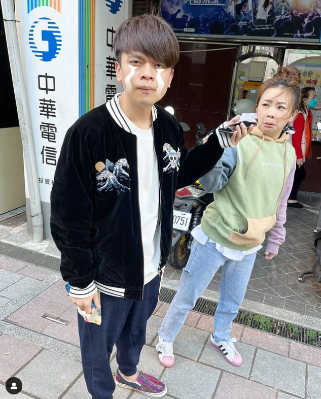 蔡阿嘎與老婆二伯站在電信行門口。 圖：翻攝自IG/yga0721