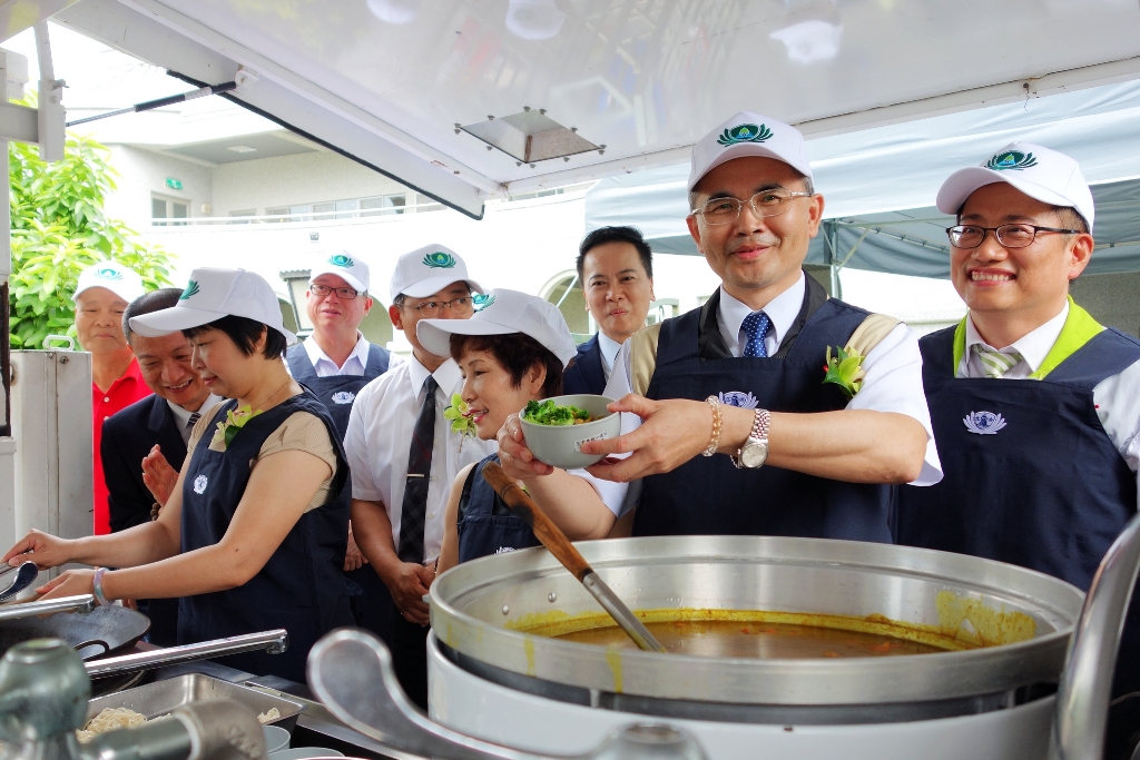台南市副市長曾旭正穿上圍裙體驗行動餐車，烹煮熱食給與會人員享用，回顧救災行動。 圖：黃博郎/攝