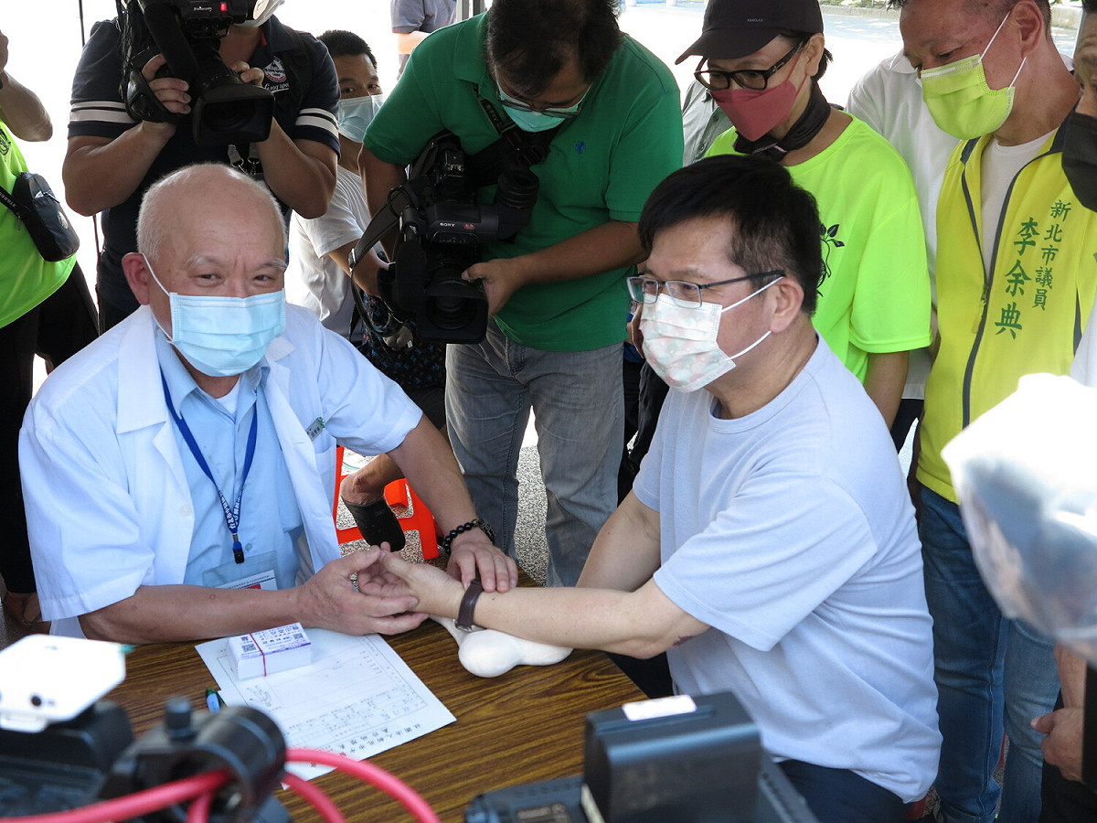新北市醫師公會、新北市中醫師公會協辦父親節活動，林佳龍接受把脈。 圖：民進黨新北市黨部提供