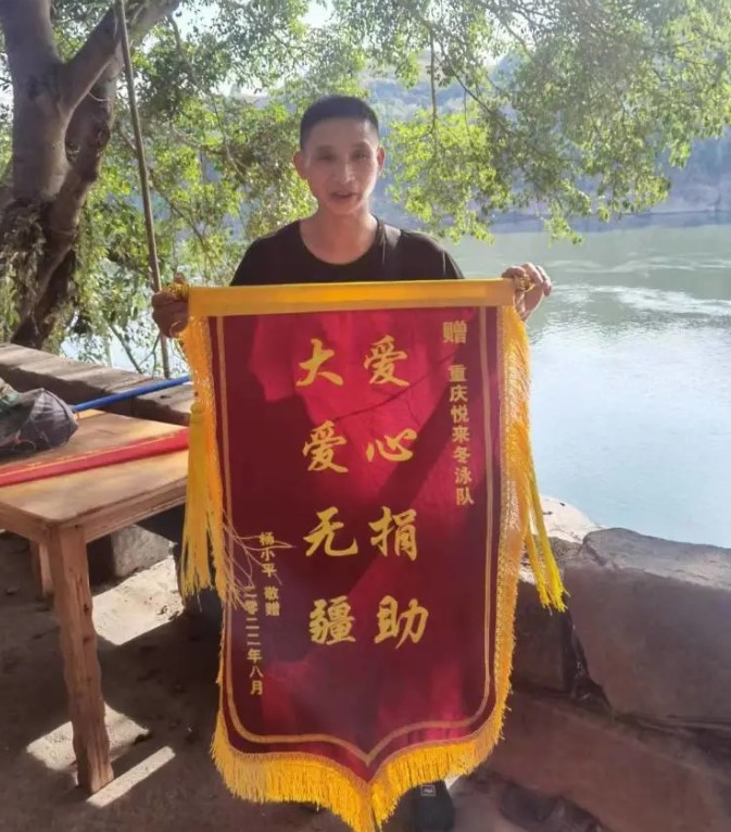 楊小平為感謝援助，致贈冬泳隊錦旗。