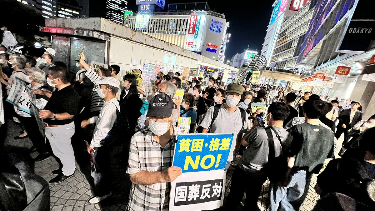 日本東京新宿站外民眾舉著「反對國葬」標語，抗議這次的安倍國葬。 圖：翻攝自推特