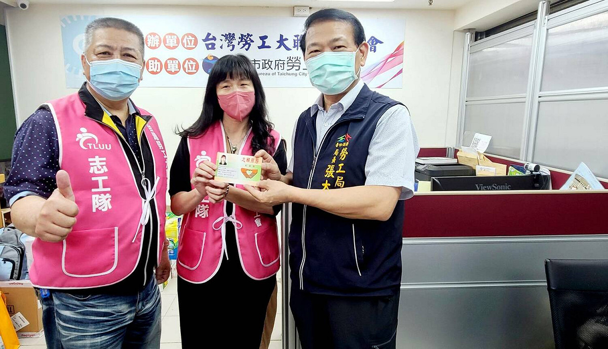 勞工局長張大春（右）頒發志願服務手冊。 台中市政府勞工局/提供