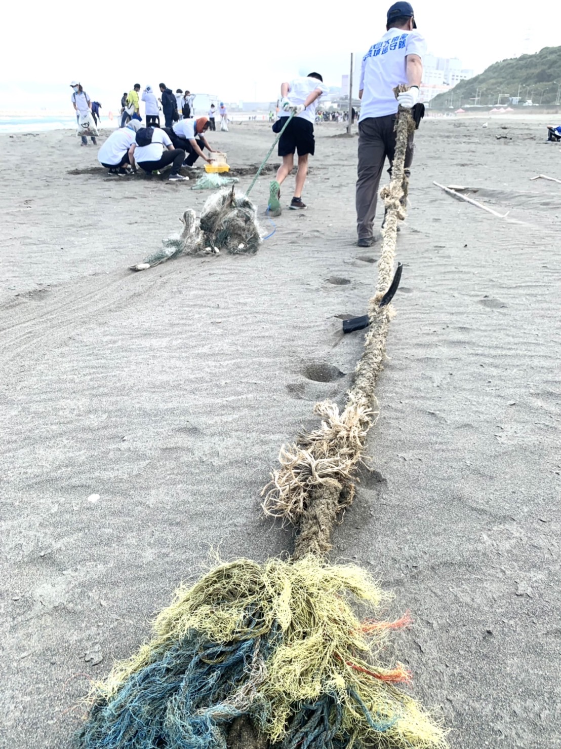 大家一起挽起衣袖清理海廢，用實際行動愛地球。 圖：新北市環保局提供