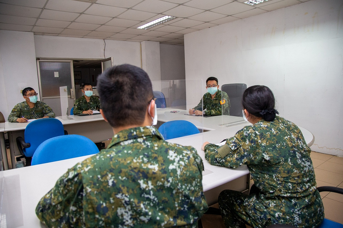國軍於室內開會，遵守防疫規定仍佩戴口罩。 圖：國防部提供
