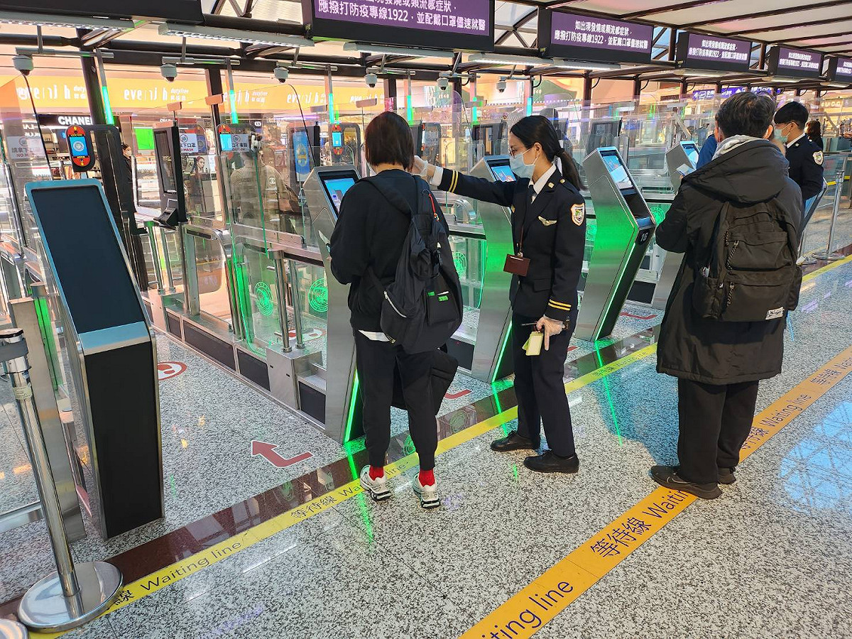 移民署執勤人員引導旅客使用自動查驗通關系統。 圖：內政部提供