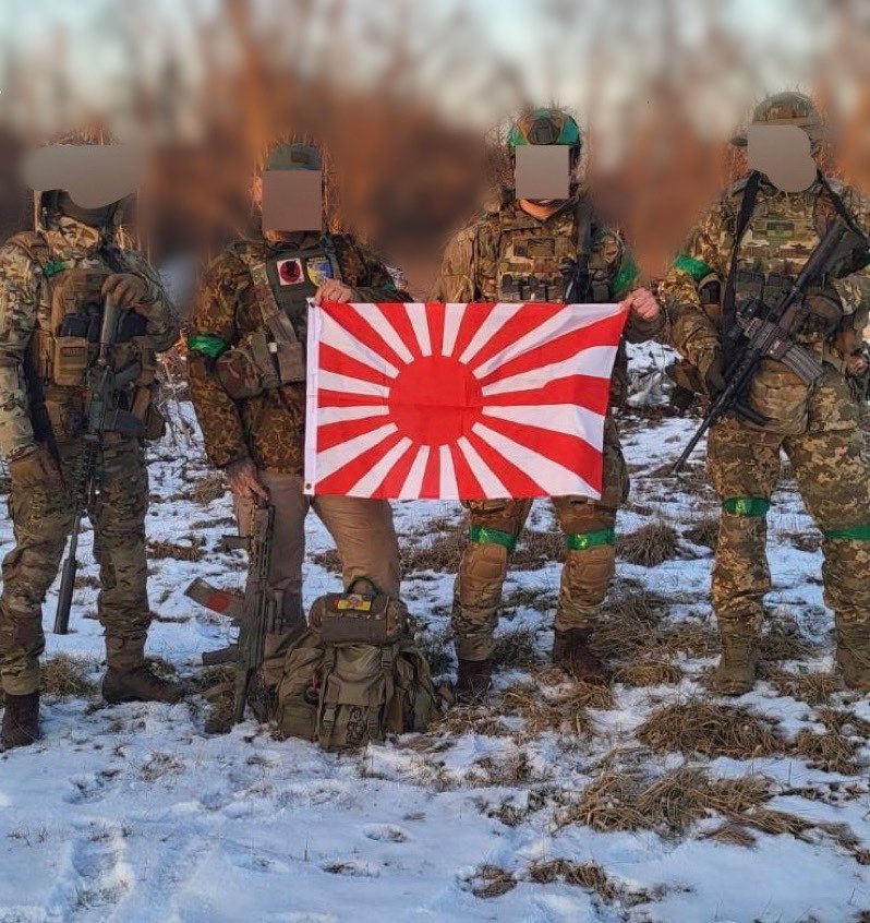 日本志願兵赴烏參戰，持旭日旗拍攝合影。 圖:翻攝自推特/MilitaryLand.net (@Militarylandnet)