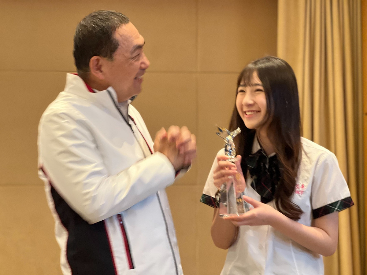 新北市長侯友宜與能仁家商學生林姵宇合照，恭賀她榮賀「技職傑出獎」。 圖：新北市教育局提供