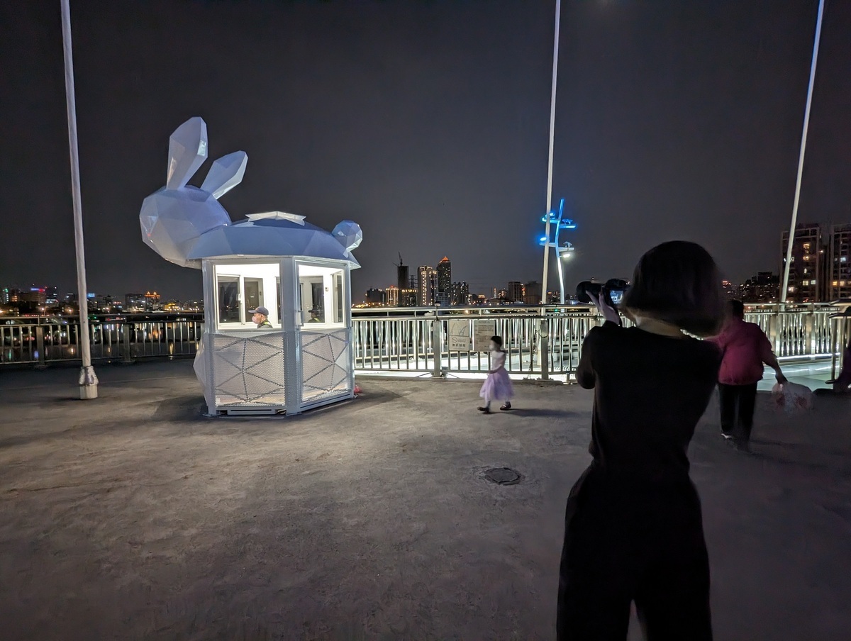 媽媽攜帶著小孩，在舒適的夜晚，來一窺保全崗哨的全新造型。 圖：新北市高灘處提供