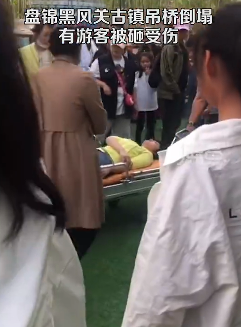吊橋下遊客頭部遭撞擊，被救護人員緊急就醫。 圖:翻攝自微博