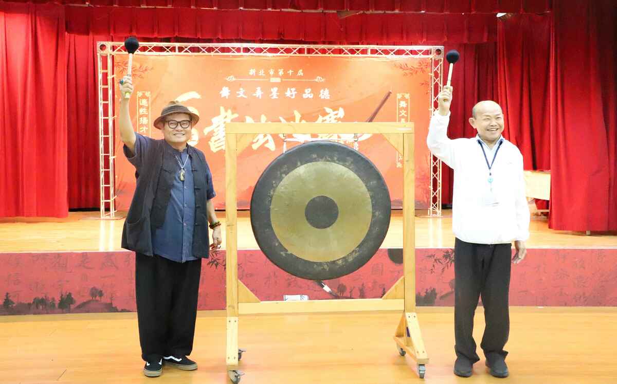 藝人許效舜（左）與教育局副局長歐人豪（右）共同敲鑼，宣布比賽正式開始。 圖：新北市教育局提供