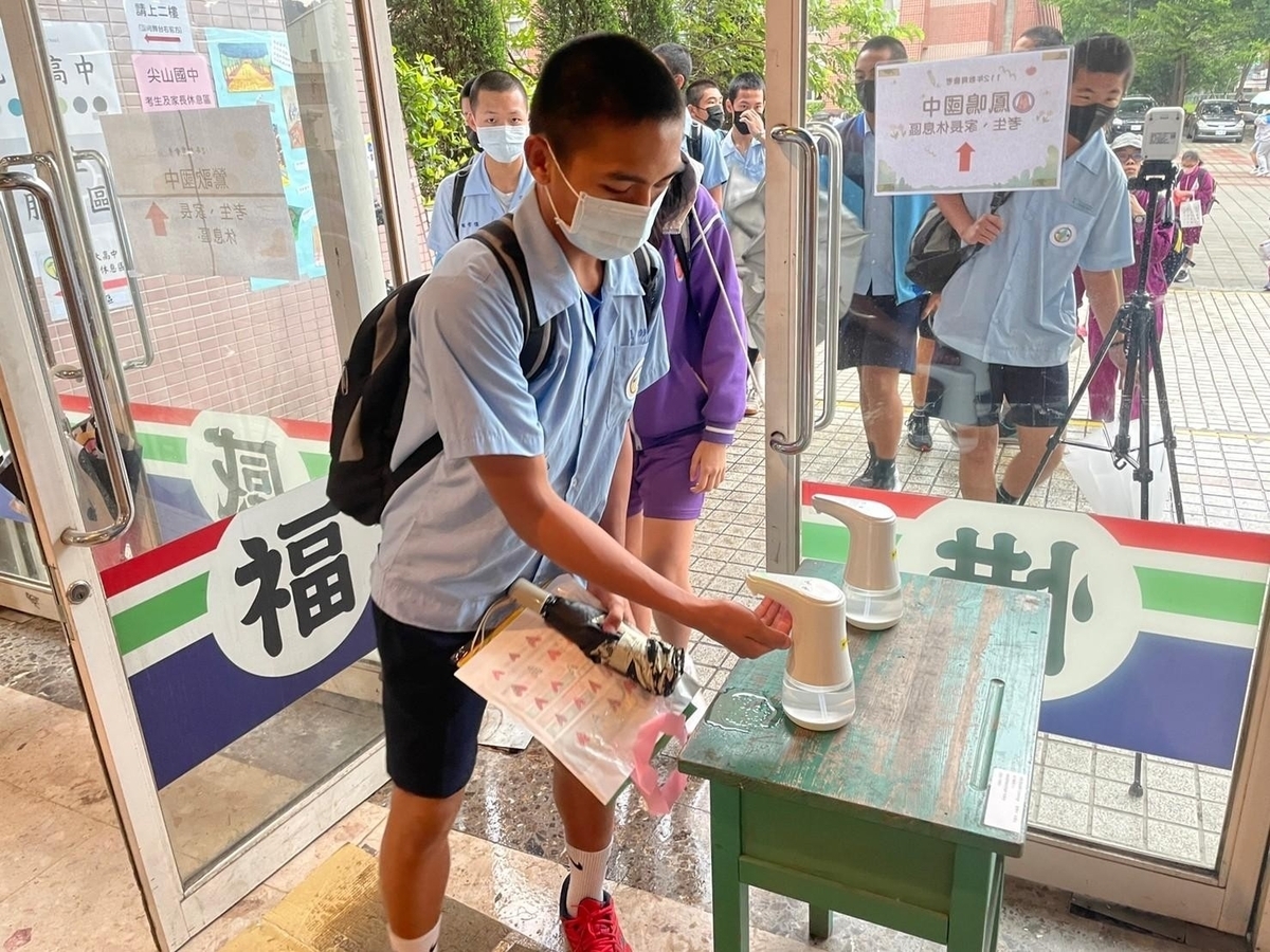 考生進入考場前做手部消毒。 圖：新北市教育局提供