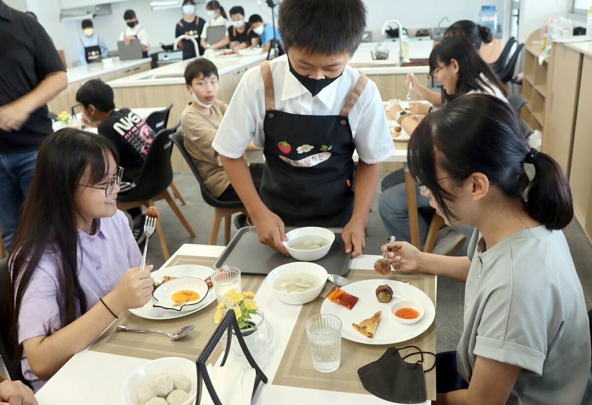 畢業生分別扮演服務生與顧客的角色。 圖：高雄市教育局提供