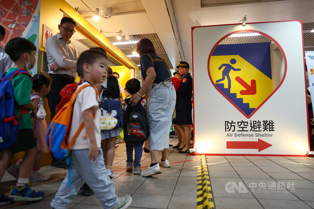 內政部警政署特別規劃「守護之盾－防空避難體驗特展」，2日起在台北捷運西門站正式登場，現場設有防空避難標示的打卡牆，宣導民防意識。中央社記者王騰毅攝  114年7月2日