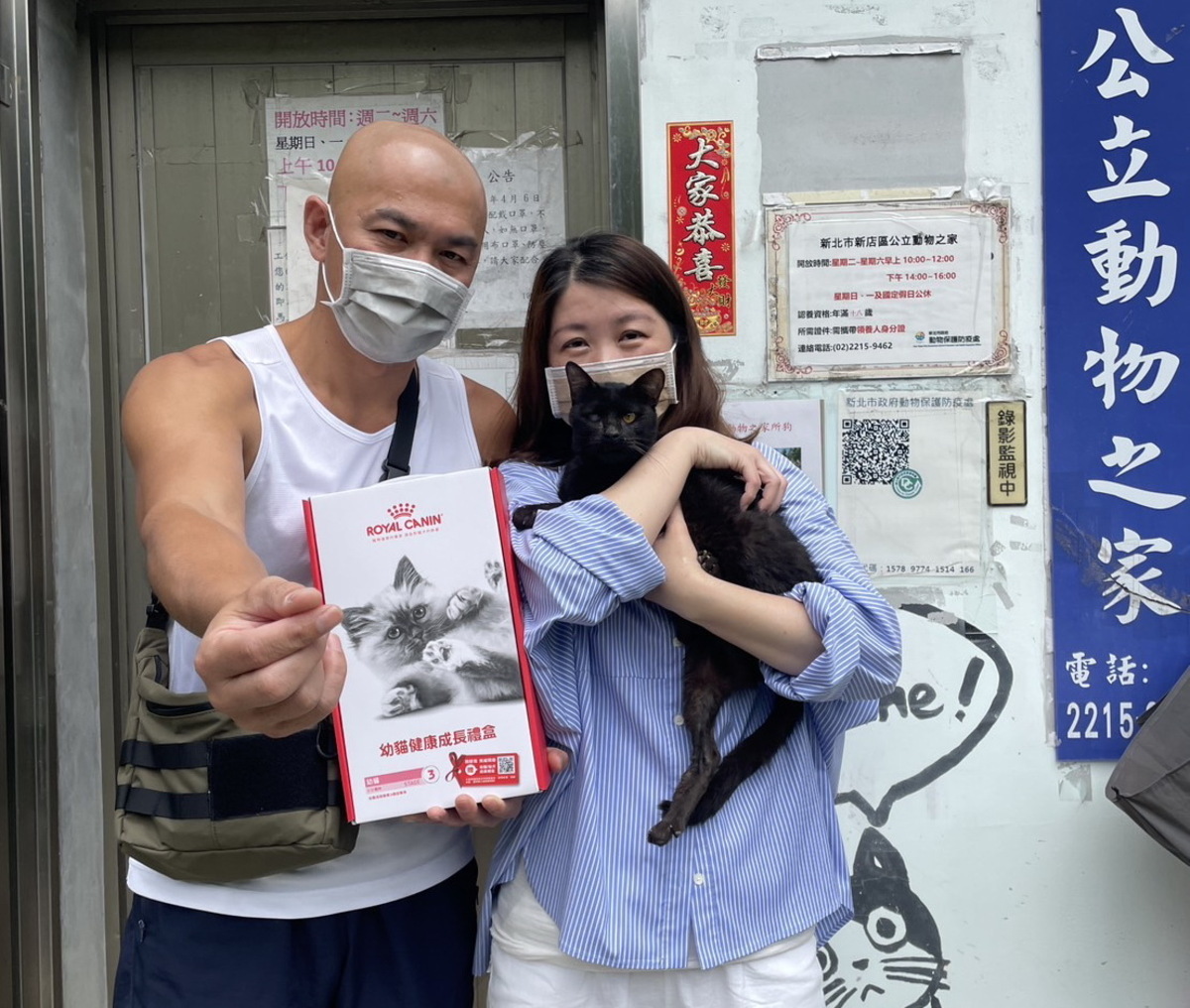 孫大偉夫婦辦完認養手續準備帶小黑貓回家。 圖：新北市動保處提供