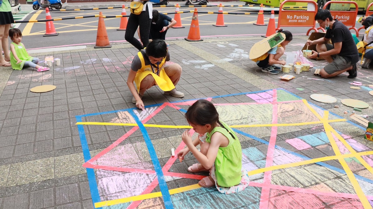 「街道遊戲實驗」是台灣還我特色公園行動聯盟帶領現場大小朋友，利用紙箱、線繩等素材在街道上佈置與遊戲，透過遊戲方式讓孩子們摸索街道空間，激發大小朋友對於人行環境的關心。 圖：新北市工務局提供