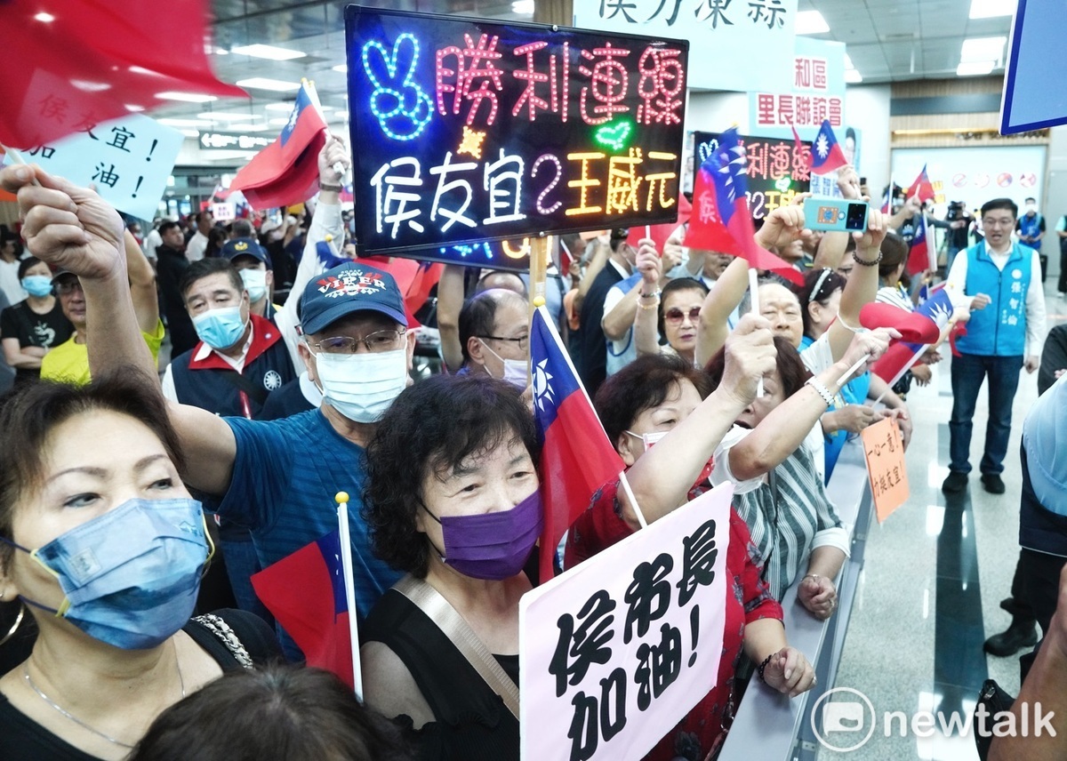 侯友宜的支持者拿著各式手舉牌在松山機場入境大廳歡迎侯友宜。 圖：張良一/攝