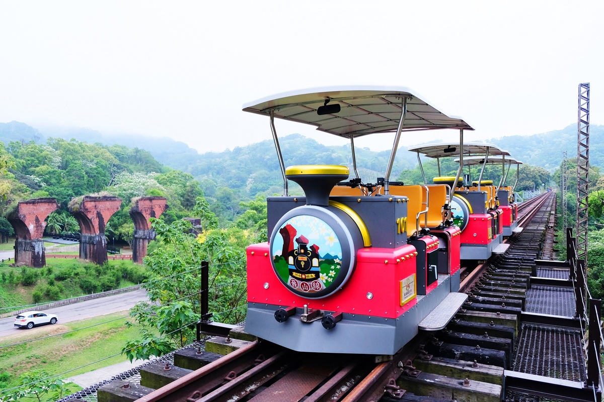 搭乘舊山線鐵道自行車體驗低碳旅遊。 苗栗縣政府/提供