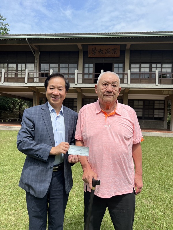 東海大學經濟系校友丁善玖（右）特地從海外返台，杵著拐杖隻身搭客運返回母校捐110萬美金。. 東海大學/提供