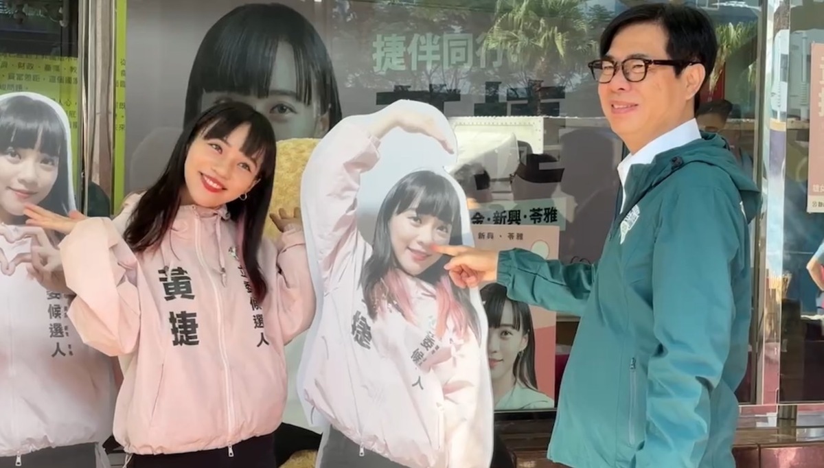 陳其邁(右)調皮戳黃捷人形立牌的鼻孔，本尊哭笑不得。 圖：黃捷競總/提供