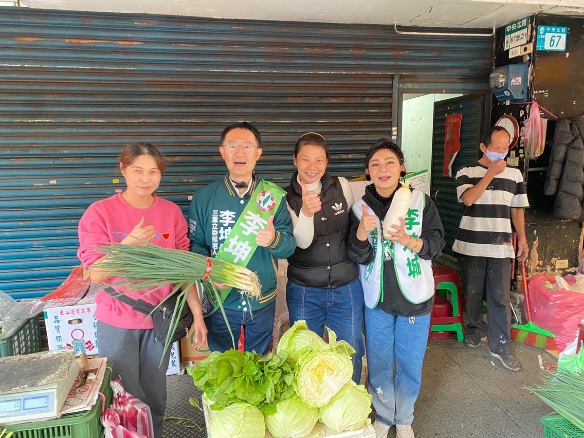 保庇天后王彩樺陪同李坤城到三和市場掃街拜票，攤商老闆送給李坤城菜頭（好彩頭）及蒜頭、蒜苗（凍蒜）。 圖：李坤城競選總部提供