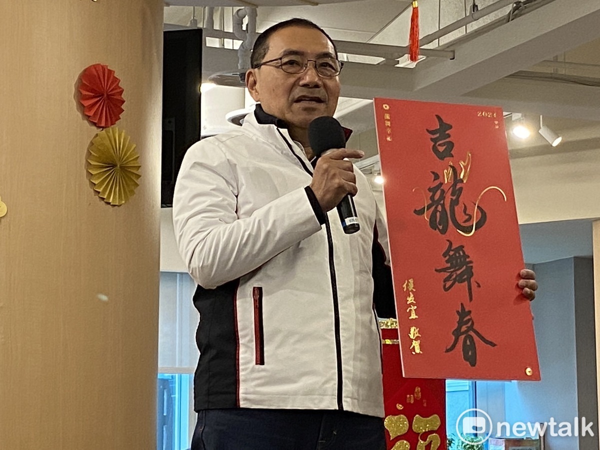 侯友宜開箱龍年春聯「吉龍舞春」，取台語諧音祝大家「錢都有餘」。 圖：林昀真/攝
