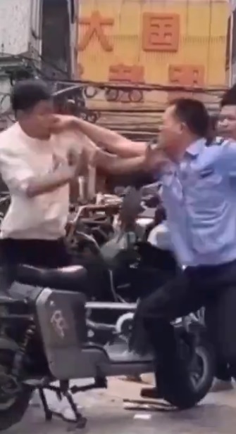 有些中國警察不僅僅在路口攔民眾的電動車，甚至直接到工廠門口、家門口直接搶電動車。圖為被搶電動車民眾與警察發生衝突。 圖：翻攝自沐陽 X（前推特）帳號