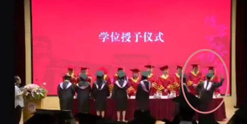 6 月 19 日，復旦法學院 2019 級本科生夏姓台生在學院畢業典禮上，到主席台前攻擊老師。 圖 : 翻攝自微博