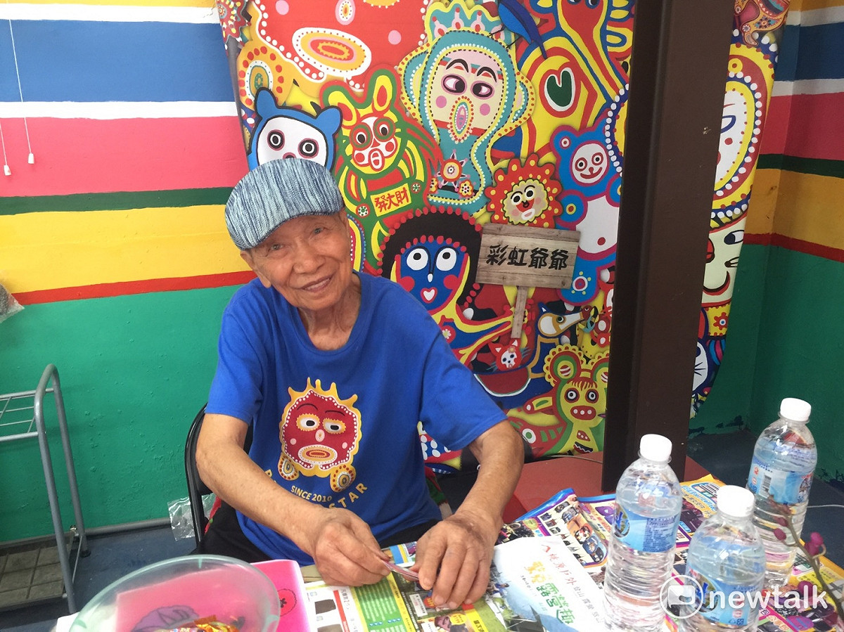 彩虹爺爺絲毫沒有名人的架子，親自坐鎮接待來訪的旅客們，凡是來過彩虹村的人都搶著跟爺爺照相。 圖：陳奕/攝影