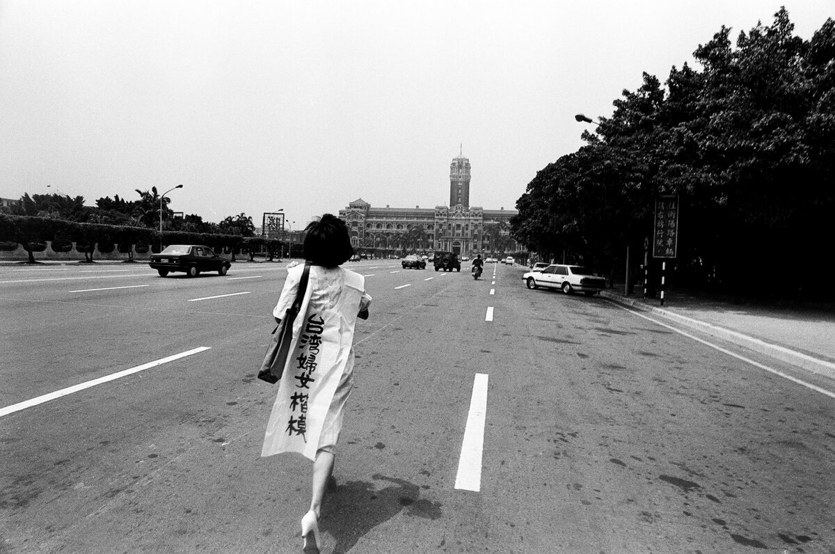 1988年8月26日，陳翠玉送葬隊伍臨時決議衝撞總統府，聲援與救援海外黑名單無役不與的「進步婦盟」林秋滿穿著高跟鞋，率先衝往總統府。  圖：邱萬興/攝