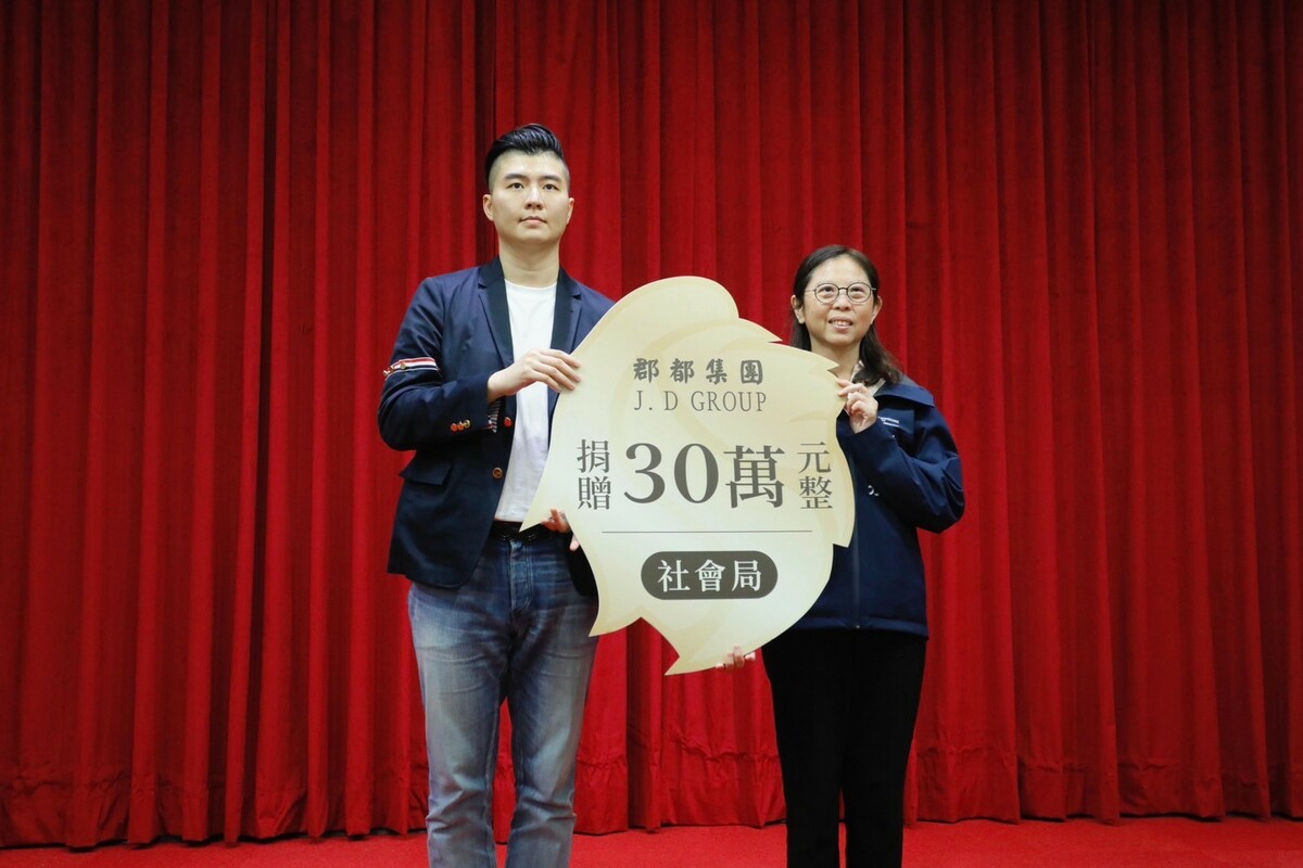 唐承(左)代表捐30萬元善款給高市社會局。 圖：郡都集團/提供