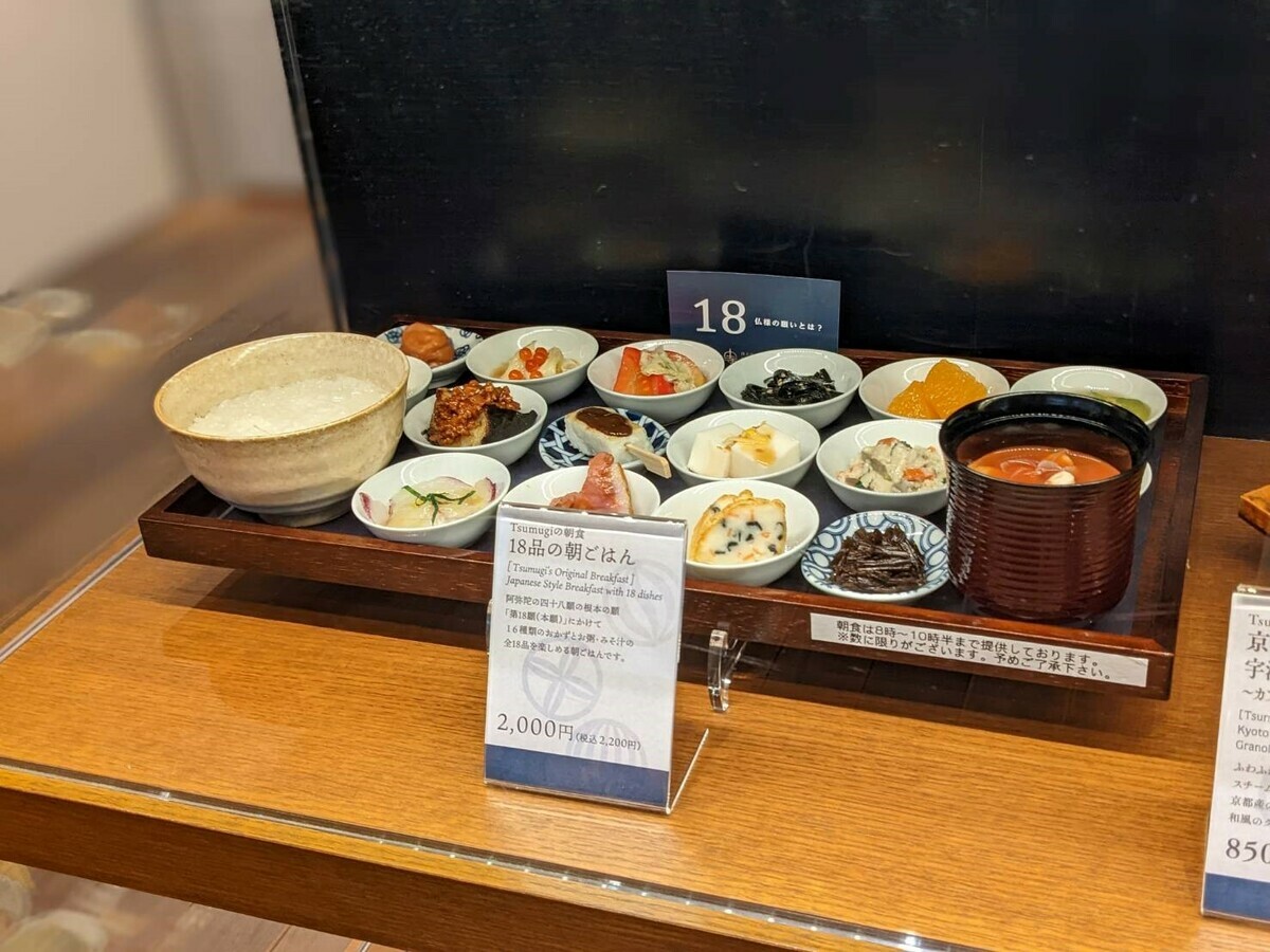 有紀文炸魚板、江戶一昆布佃煮、松露玉子燒等16種美味小菜，加上清粥及味噌湯合成18樣菜色的人氣餐點「18道品早飯」。 圖：©Tsukiji Hongwanji／提供