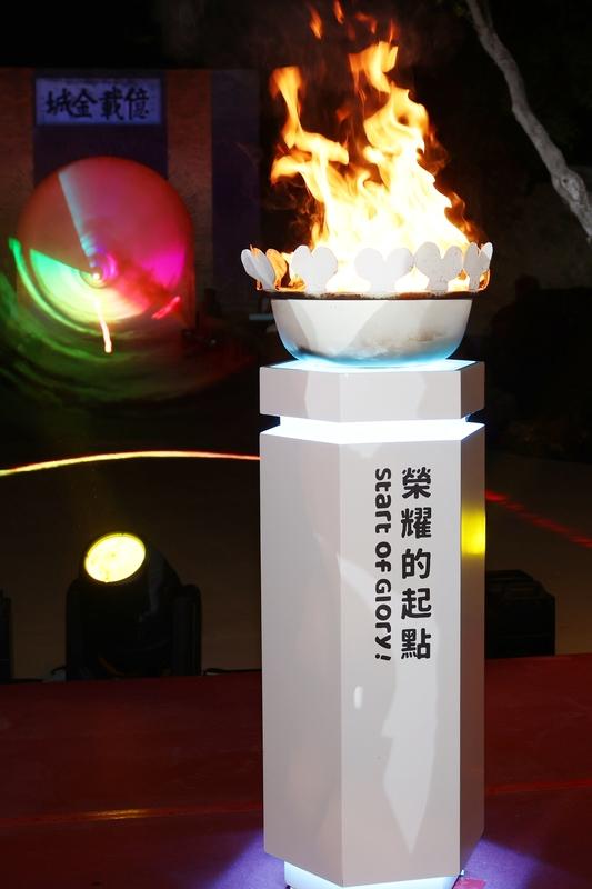 聖火火鉅使用3D列印技術，頂端合金為波浪造型，並鑲刻本次全中運吉祥物大員與甜甜及大會口號「Start of Glory!」，母火盆同樣以波浪造型合金耐高溫材質製作，極具臺南特色，將承載所有選手及與會者的夢想與榮耀前進。 圖：台南市政府提供