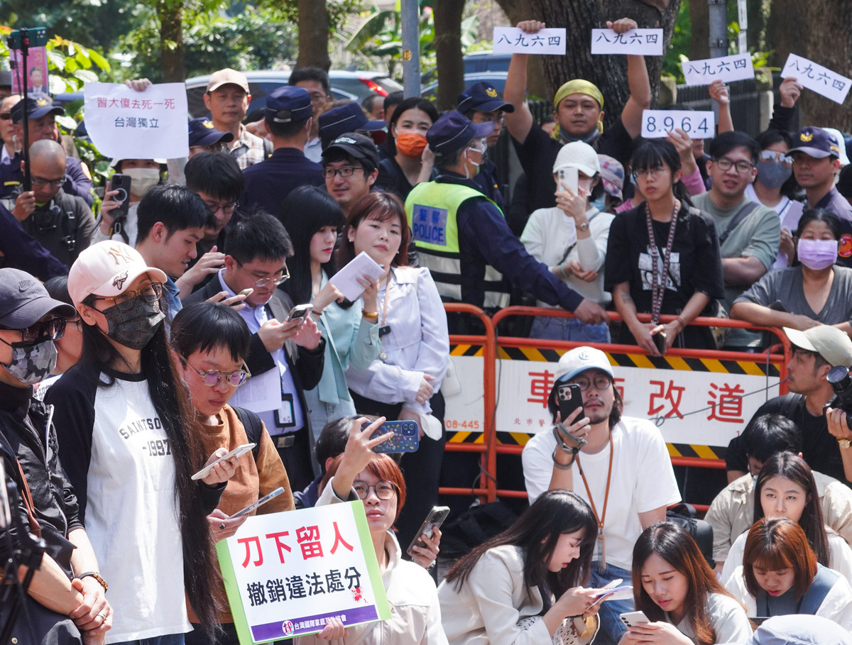 中配網紅「亞亞」劉振亞在台灣國際家庭互助協會的陪同下，今（25）天在內政部大樓門口前召開記者會訴求撤銷對她的行政處分。場外群眾則在警方維護下，於外側聚集嗆聲喊「滾出去」。 圖：張良一/攝