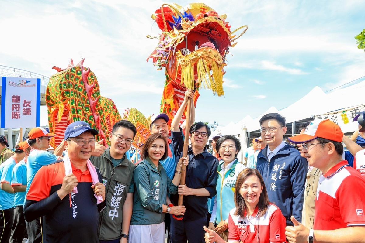 陳其邁(中)舉龍頭，邱議瑩伸手協助，隱約有「接棒」的意味。 圖：高雄市政府/提供
