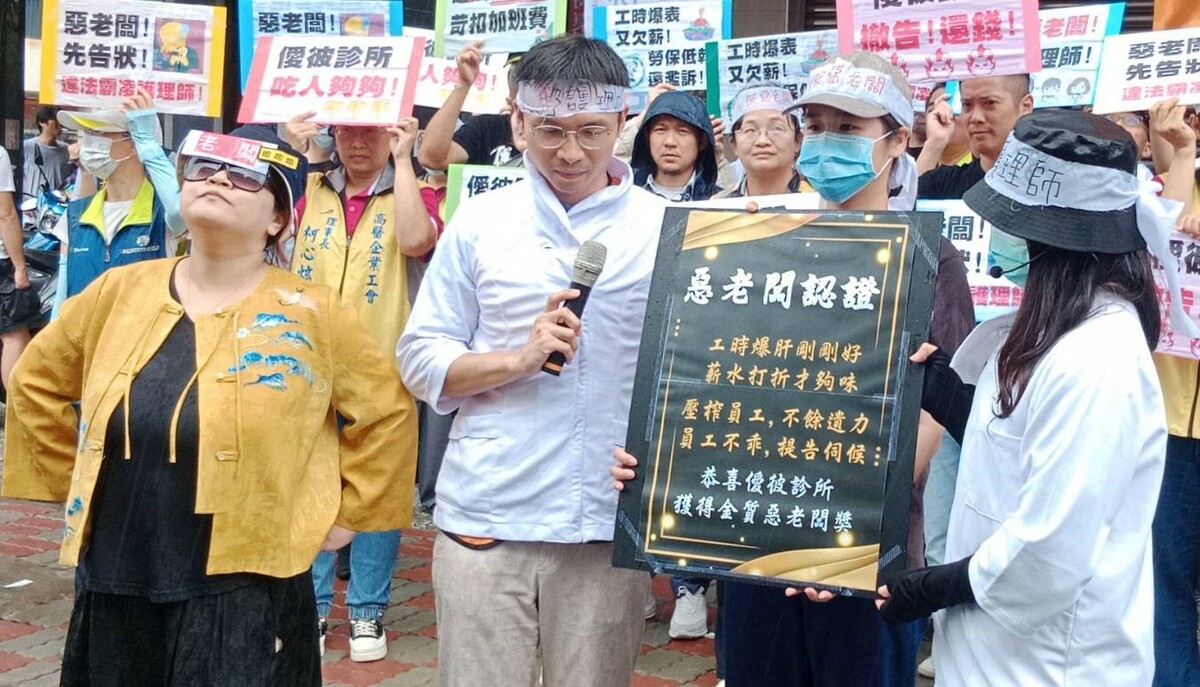 抗議人士頒「惡老闆認證」給該非法壓榨護理師的僾彼診所。 圖：孫家銘攝