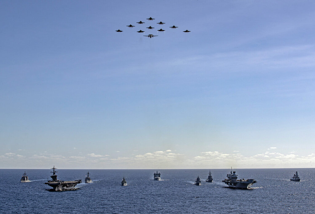 由英國航空母艦「威爾斯親王號」（右前）領軍的打擊群18日在澳洲歷來最大規模「護身軍刀」軍演期間，與美國航艦「喬治華盛頓號」（左前）領軍的打擊群首度展現英美「雙航艦」打擊群編隊航行操演陣容。 圖：英國國防部提供